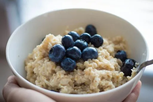 Bowl of oatmeal topped with blueberries