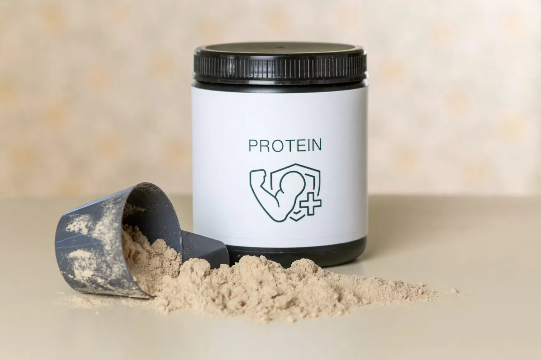 A jar of protein powder next to a scoop of powder