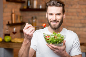 Vegan man eating a salad